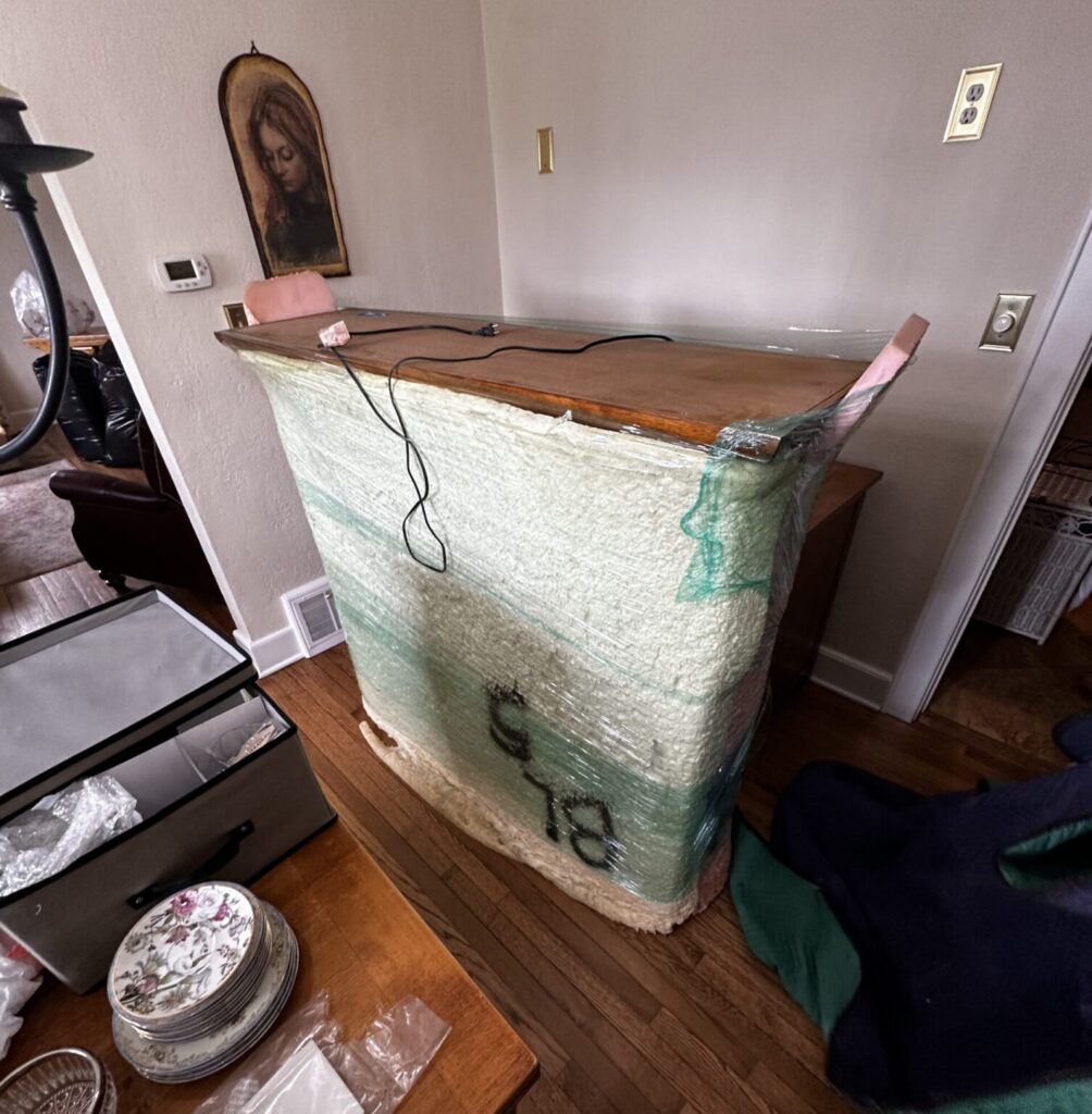 Team efficiently hauling furniture, showcasing Upper 90 Solutions' reliable junk removal and moving service.